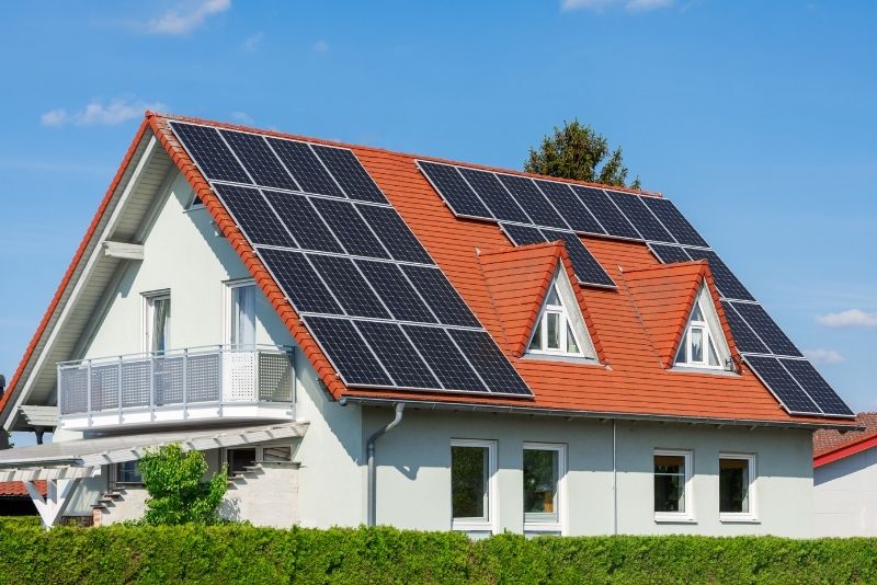 brick house with tile roof with solar panels